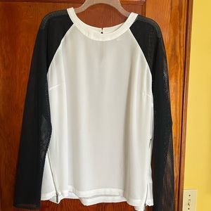White blouse with black mesh sleeves; fun zipper accents